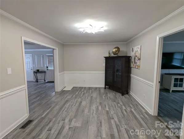 a view of a hallway with wooden floor and closet