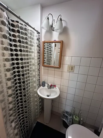 a bathroom with a sink toilet and a mirror