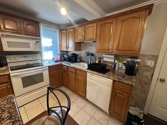 a kitchen with a stove a sink and a microwave