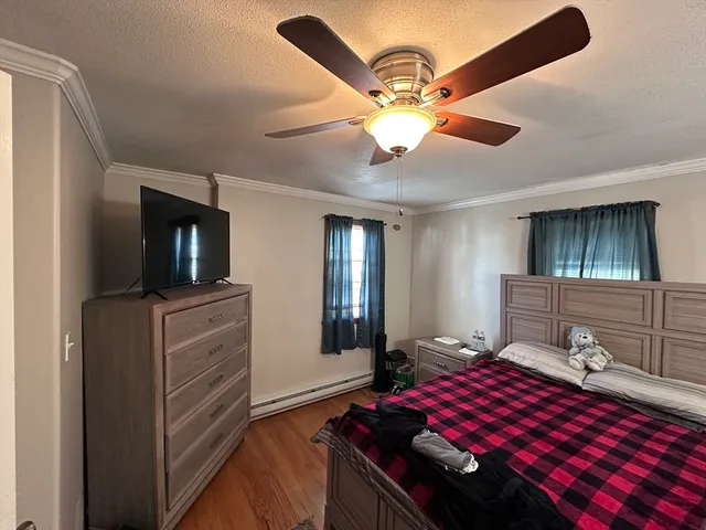 a bedroom with a large bed and a tv