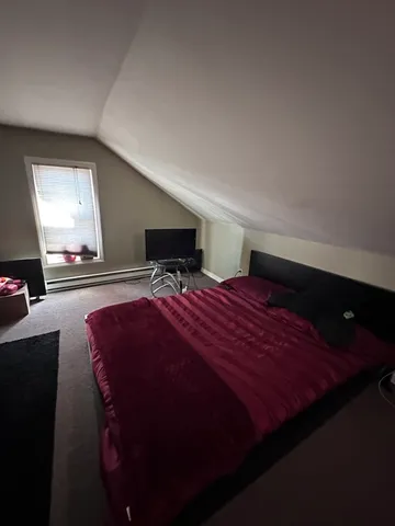 a bedroom with a bed and a mirror