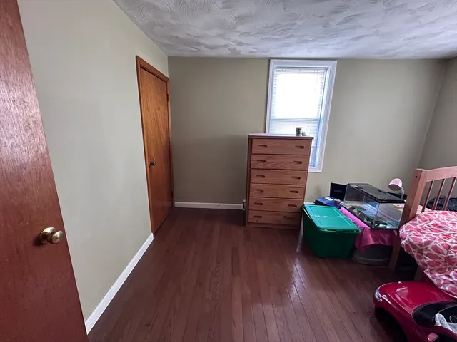 a room with a baby crib furniture and a window