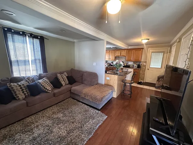 a living room with furniture fireplace and flat screen tv