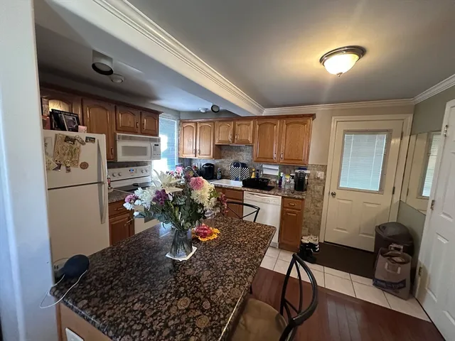 a kitchen with a refrigerator and a stove top oven