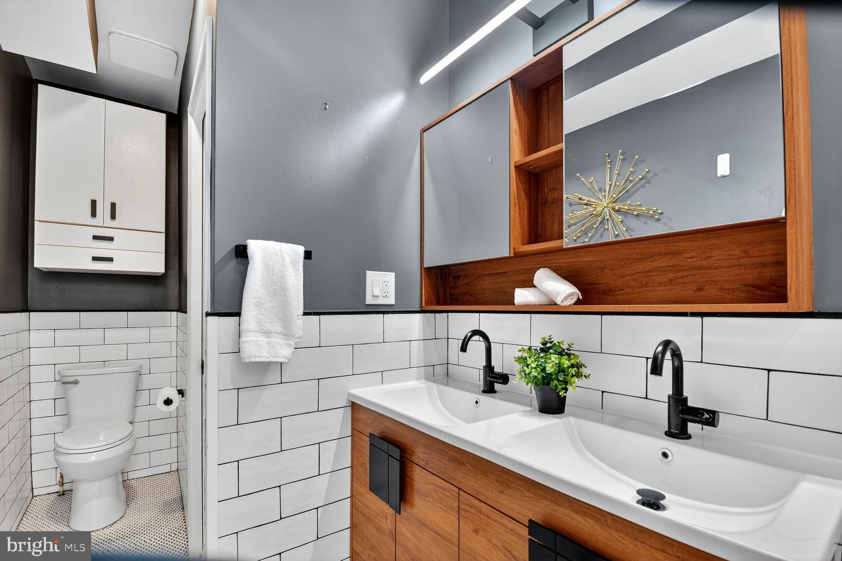 1027 6th Street Northeast Washington, DC 20002 - Photo 13 of 38 Full bathroom on 2nd level with dual vanity & tub.