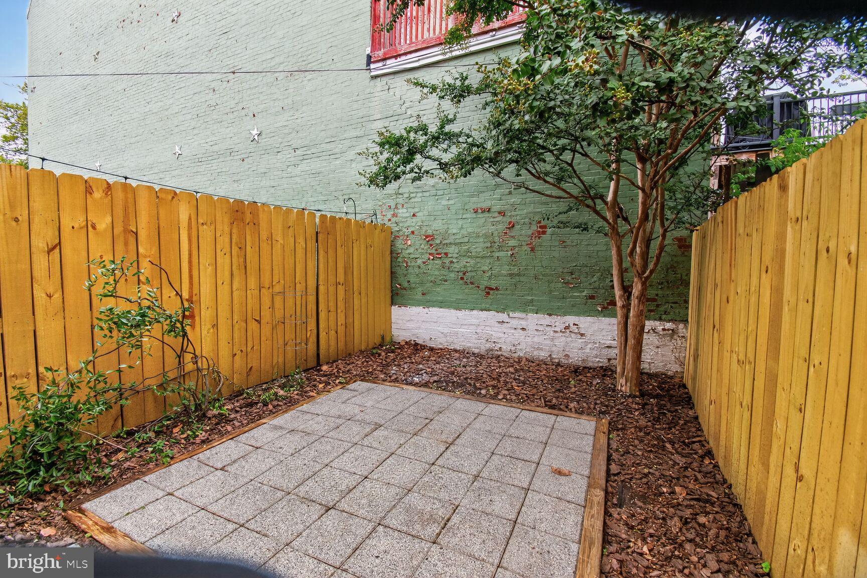 1027 6th Street Northeast Washington, DC 20002 - Photo 22 of 38 Charming outdoor space with privacy fence.