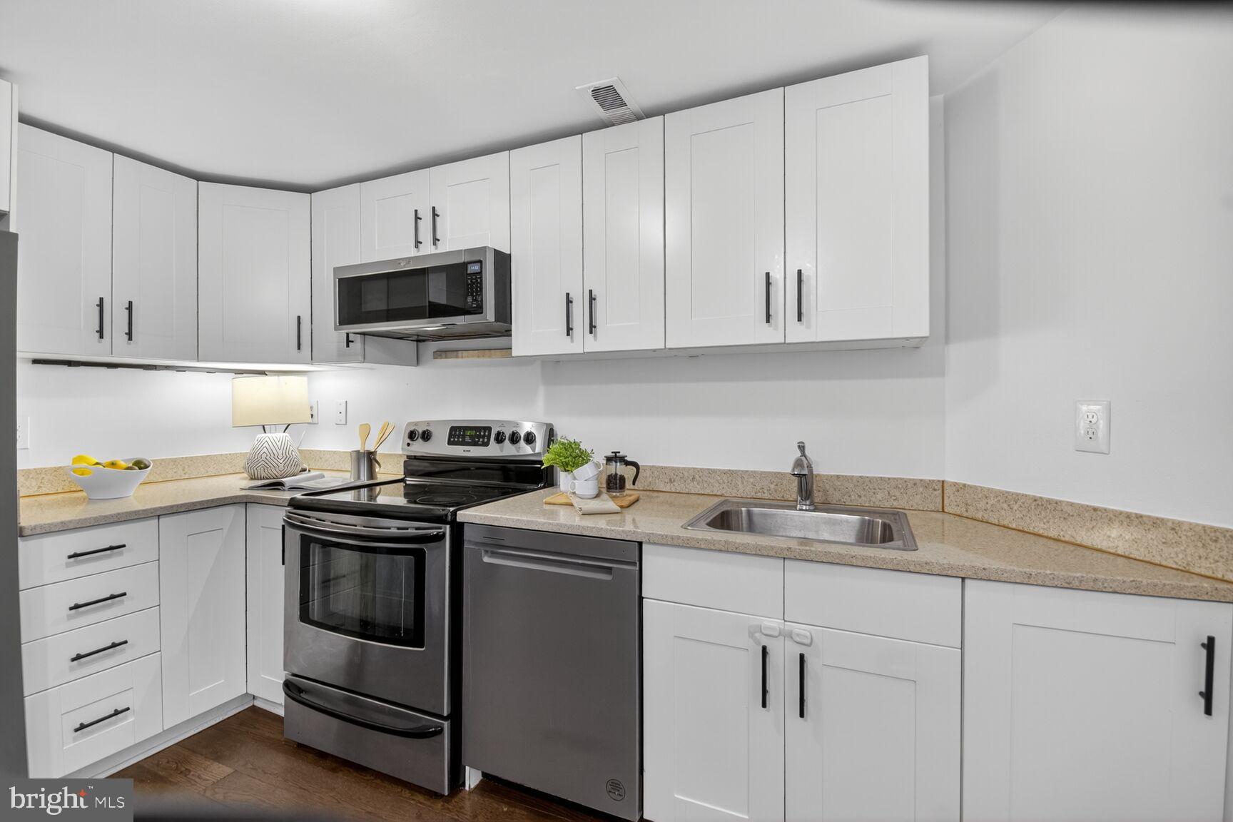 1027 6th Street Northeast Washington, DC 20002 - Photo 8 of 38 Modern kitchen with sleek white cabinetry.