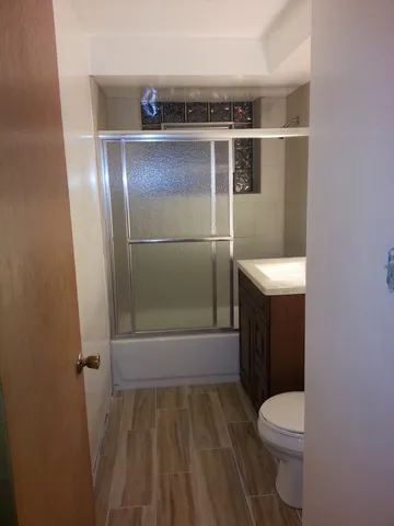 a bathroom with a toilet and a shower