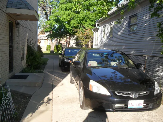 a view of a patio with table and chairs with wooden fence and plants