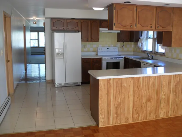 a kitchen with stainless steel appliances a refrigerator and a microwave