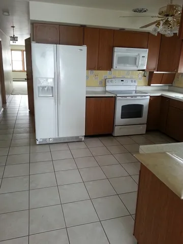 a kitchen with stainless steel appliances a sink a stove a refrigerator and cabinets