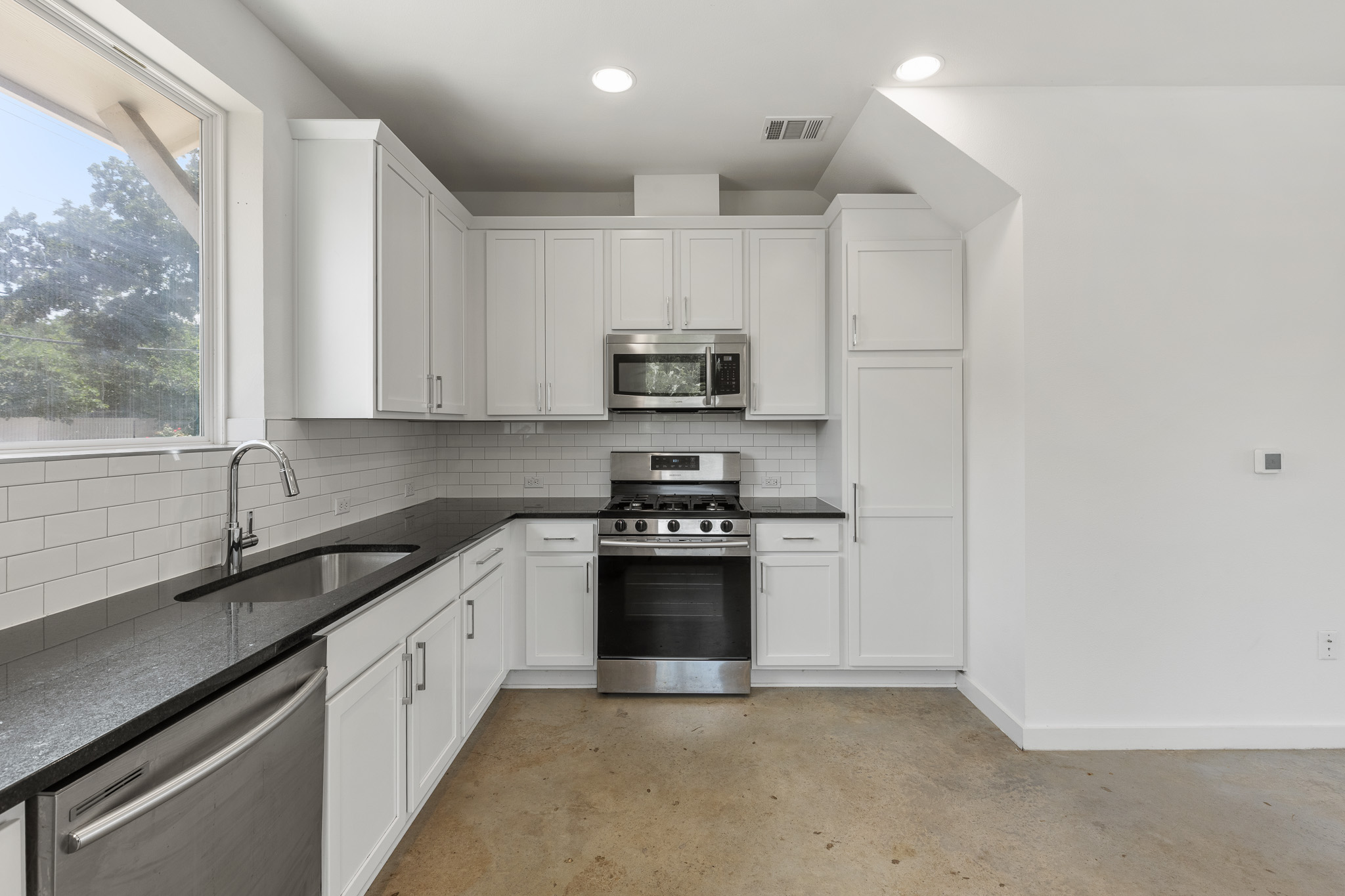 2604 Wheless Lane, Unit 1 Austin, TX 78723 - Photo 13 of 38 Black countertops provide sophisticated contrast and practical work surface.