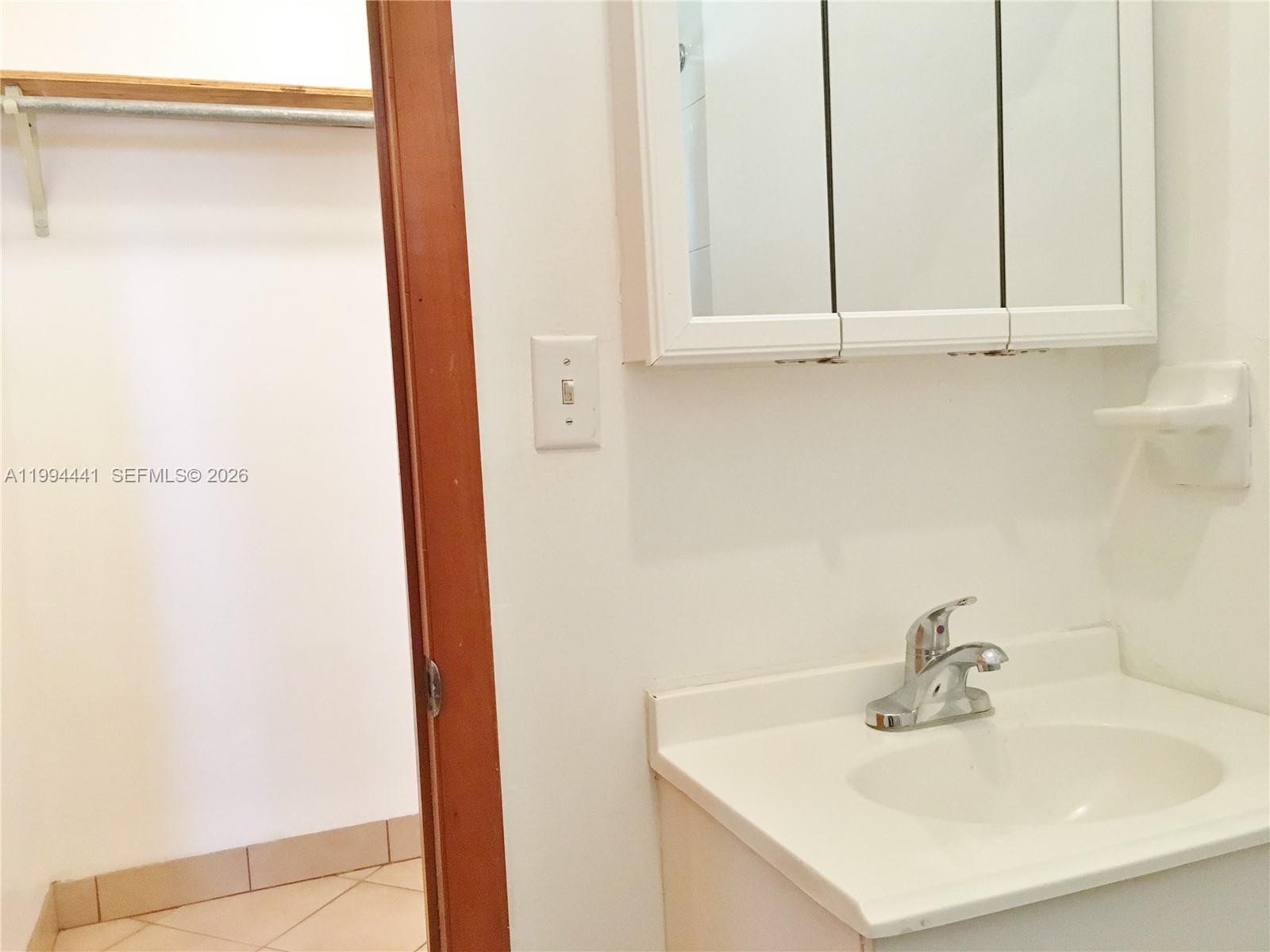 5831 Southwest 62nd Street, Unit WEST Miami, FL 33143 - Photo 11 of 16 a bathroom with a sink