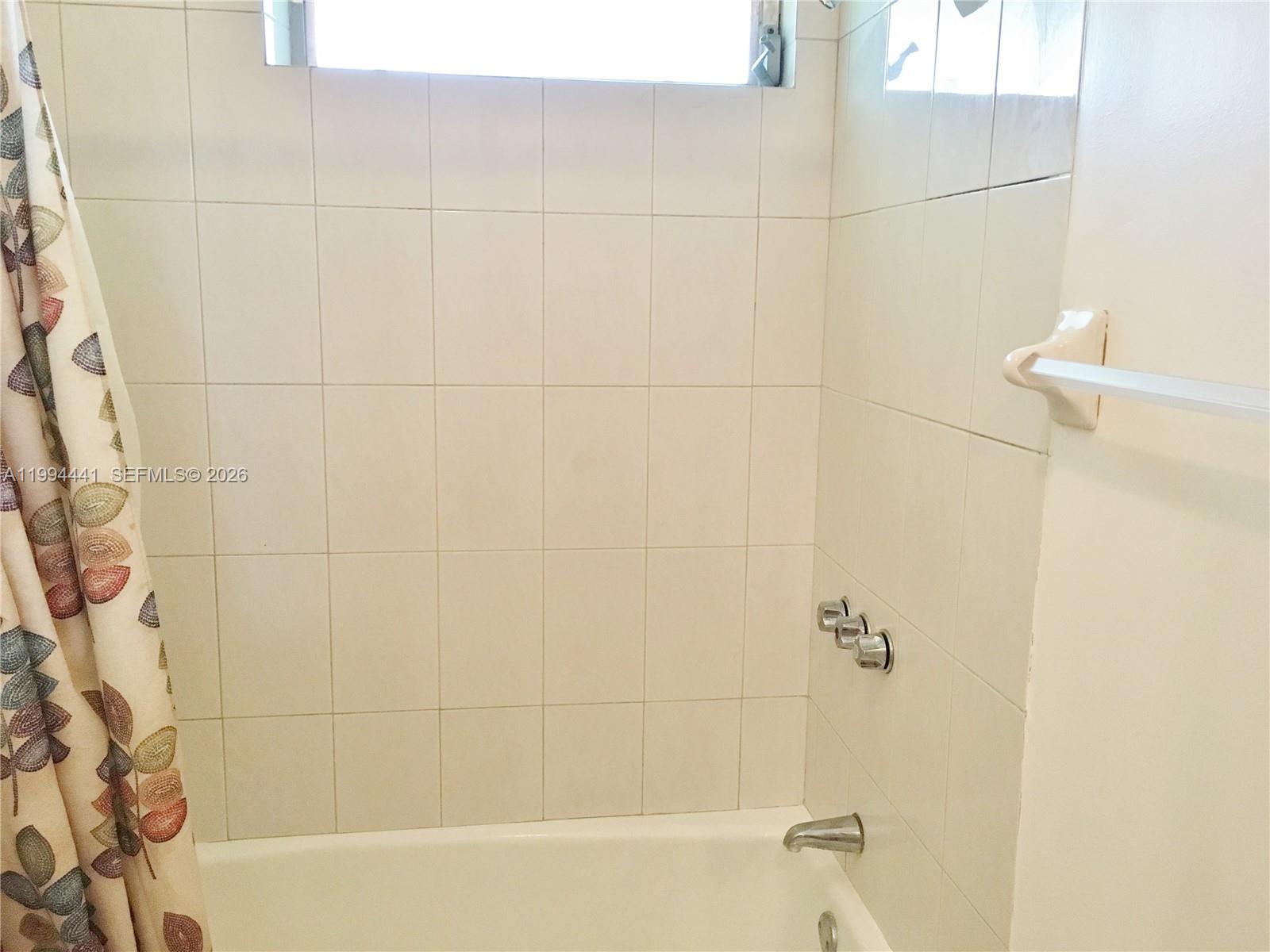 5831 Southwest 62nd Street, Unit WEST Miami, FL 33143 - Photo 12 of 16 a bathroom with a bathtub