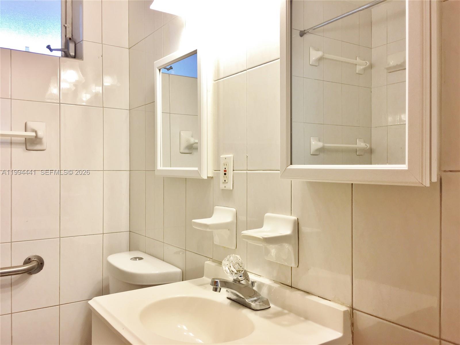 5831 Southwest 62nd Street, Unit WEST Miami, FL 33143 - Photo 10 of 16 a bathroom with a sink toilet and shower