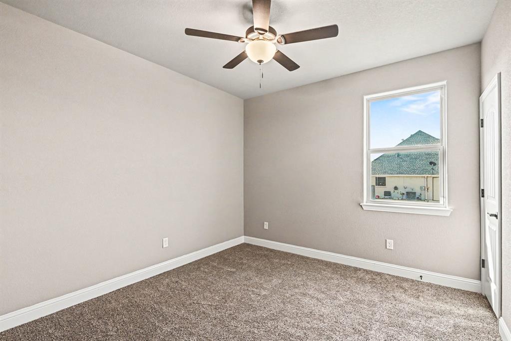 104 Stanford Lane Springtown, TX 76082 - Photo 20 of 28 an empty room with a window and a fan