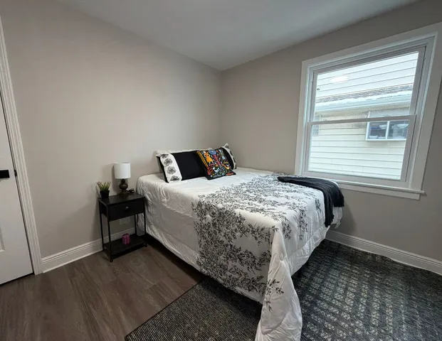 a bed sitting in a bedroom next to a window