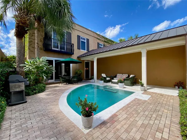 a view of a house with swimming pool patio and a yard