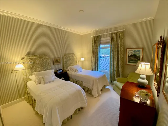 a bedroom with two beds and painted walls