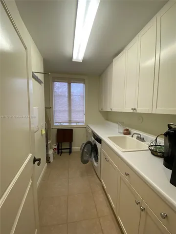 a room with a sink and cabinets