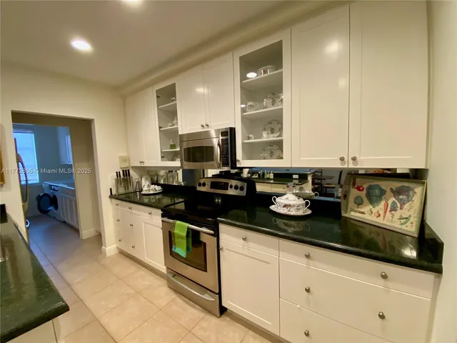 a kitchen with stainless steel appliances granite countertop a sink and cabinets