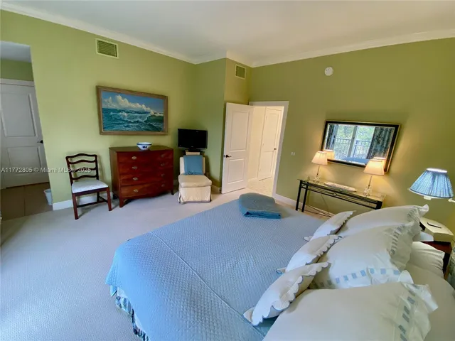 a bedroom with furniture and a flat screen tv