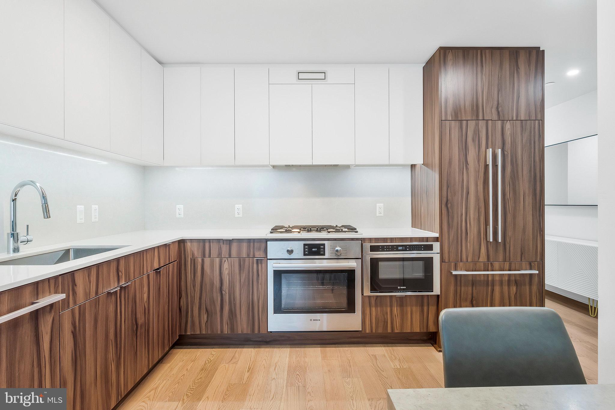 37 L Street Southeast, Unit 101 Washington, DC 20003 - Photo 11 of 34 a kitchen with stainless steel appliances granite countertop a stove a sink and a refrigerator