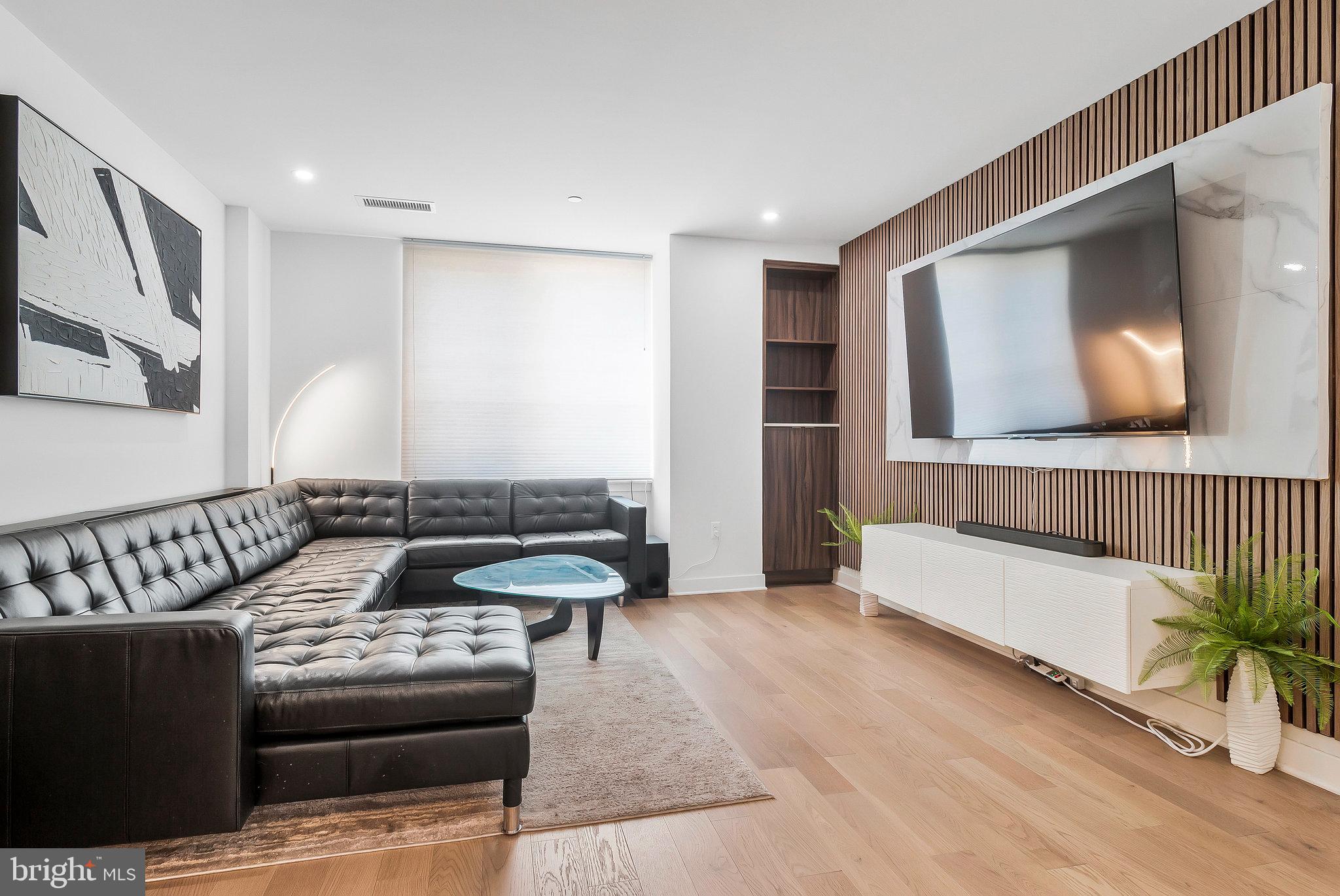 37 L Street Southeast, Unit 101 Washington, DC 20003 - Photo 13 of 34 a living room with furniture and a flat screen tv