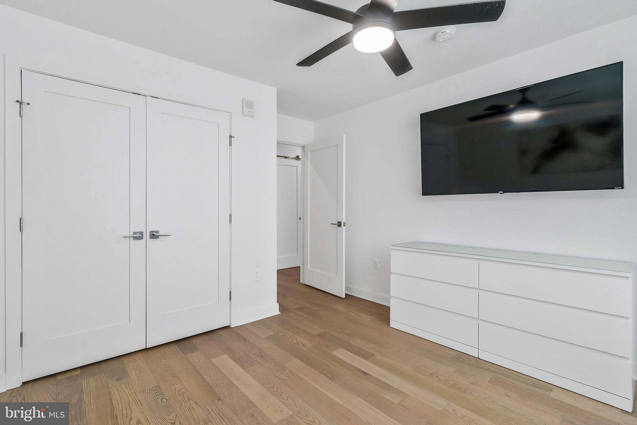 37 L Street Southeast, Unit 101 Washington, DC 20003 - Photo 21 of 34 a view of an empty room with wooden floor and a ceiling fan