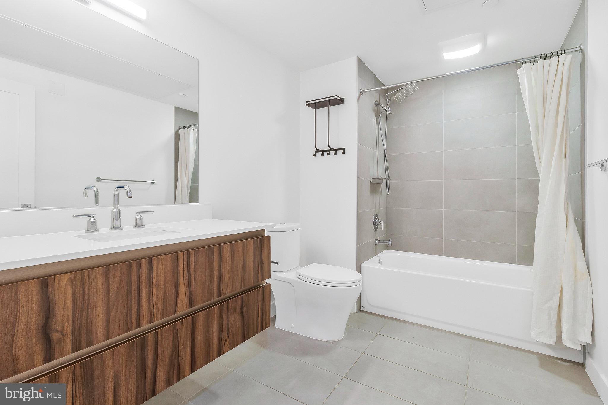 37 L Street Southeast, Unit 101 Washington, DC 20003 - Photo 23 of 34 a bathroom with a double vanity sink toilet and shower