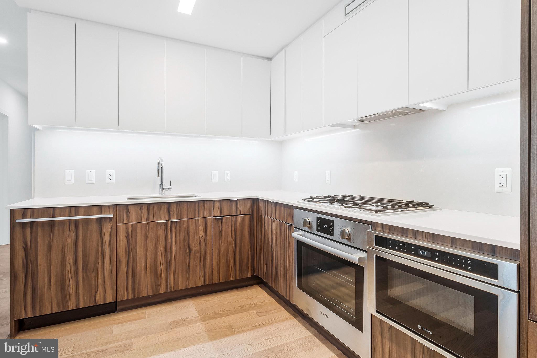 37 L Street Southeast, Unit 101 Washington, DC 20003 - Photo 8 of 34 a kitchen with granite countertop a stove and a sink