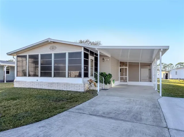 a view of a house with a yard and large window