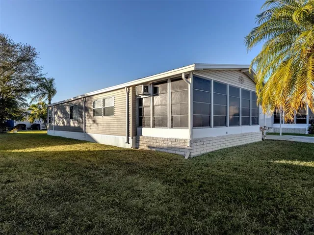 a view of a house with pool and a yard