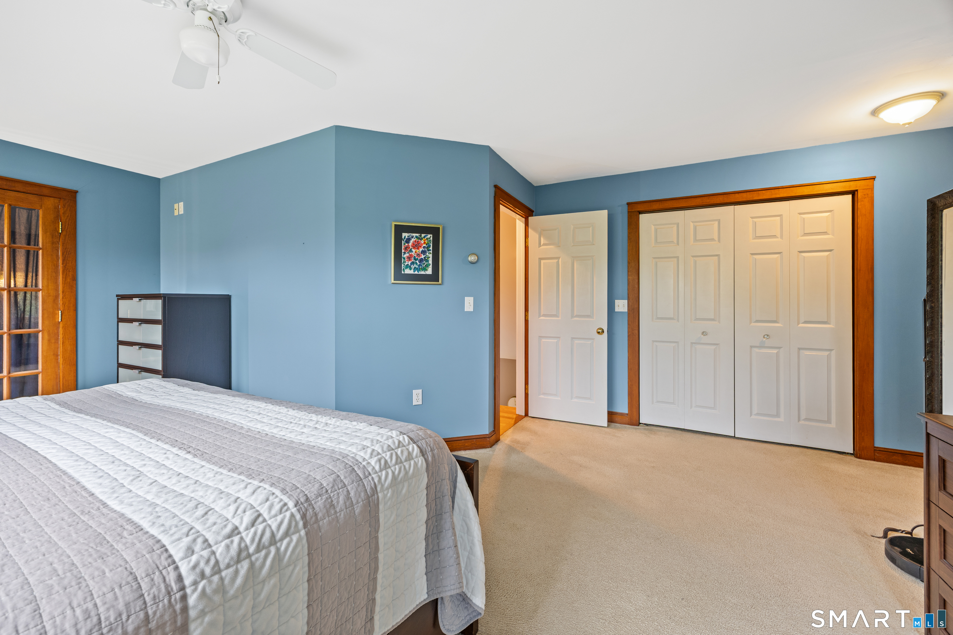 694 Millbrook Road Middletown, CT 06457 - Photo 23 of 34 a bedroom with a bed and a chandelier