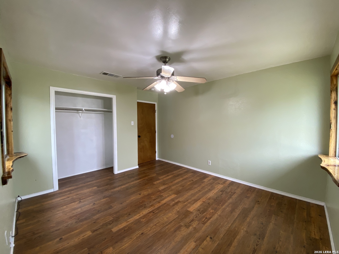 60 Wisdom Road Pleasanton, TX 78064 - Photo 16 of 29 wooden floor in an empty room with a window