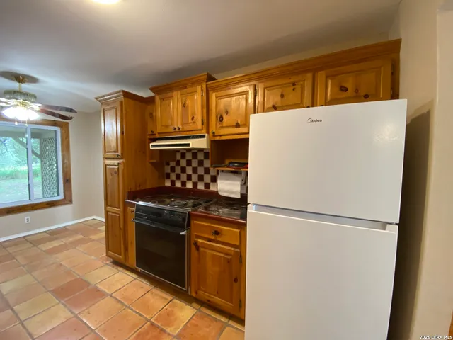 a bathroom with a granite countertop sink toilet and bathtub