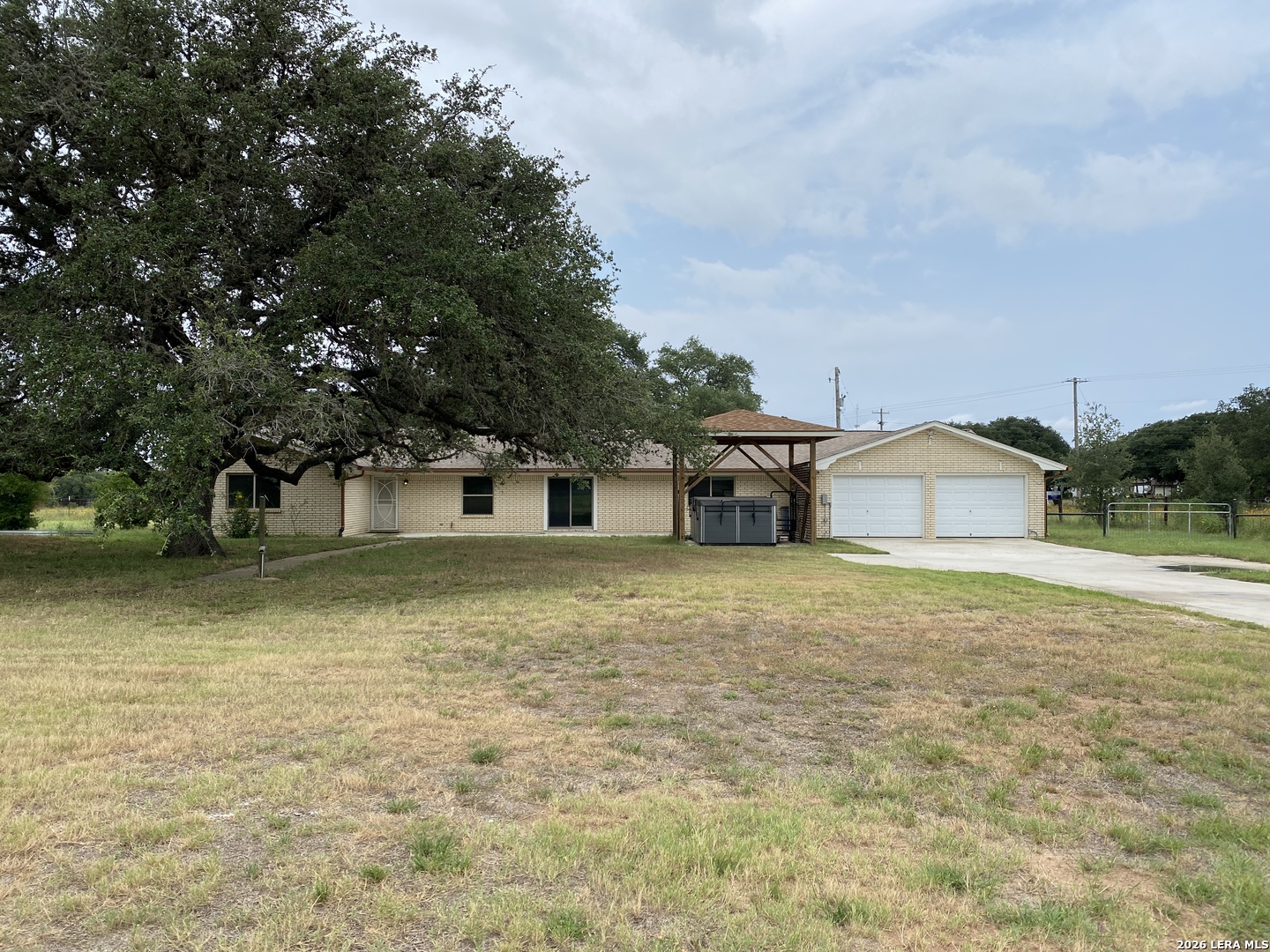 60 Wisdom Road Pleasanton, TX 78064 - Photo 21 of 29 a front view of a house with a yard and garage