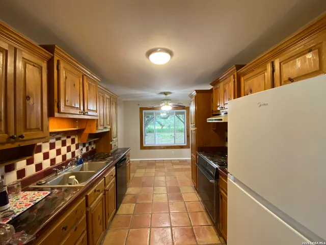 a kitchen with stainless steel appliances wooden cabinets and a counter top space