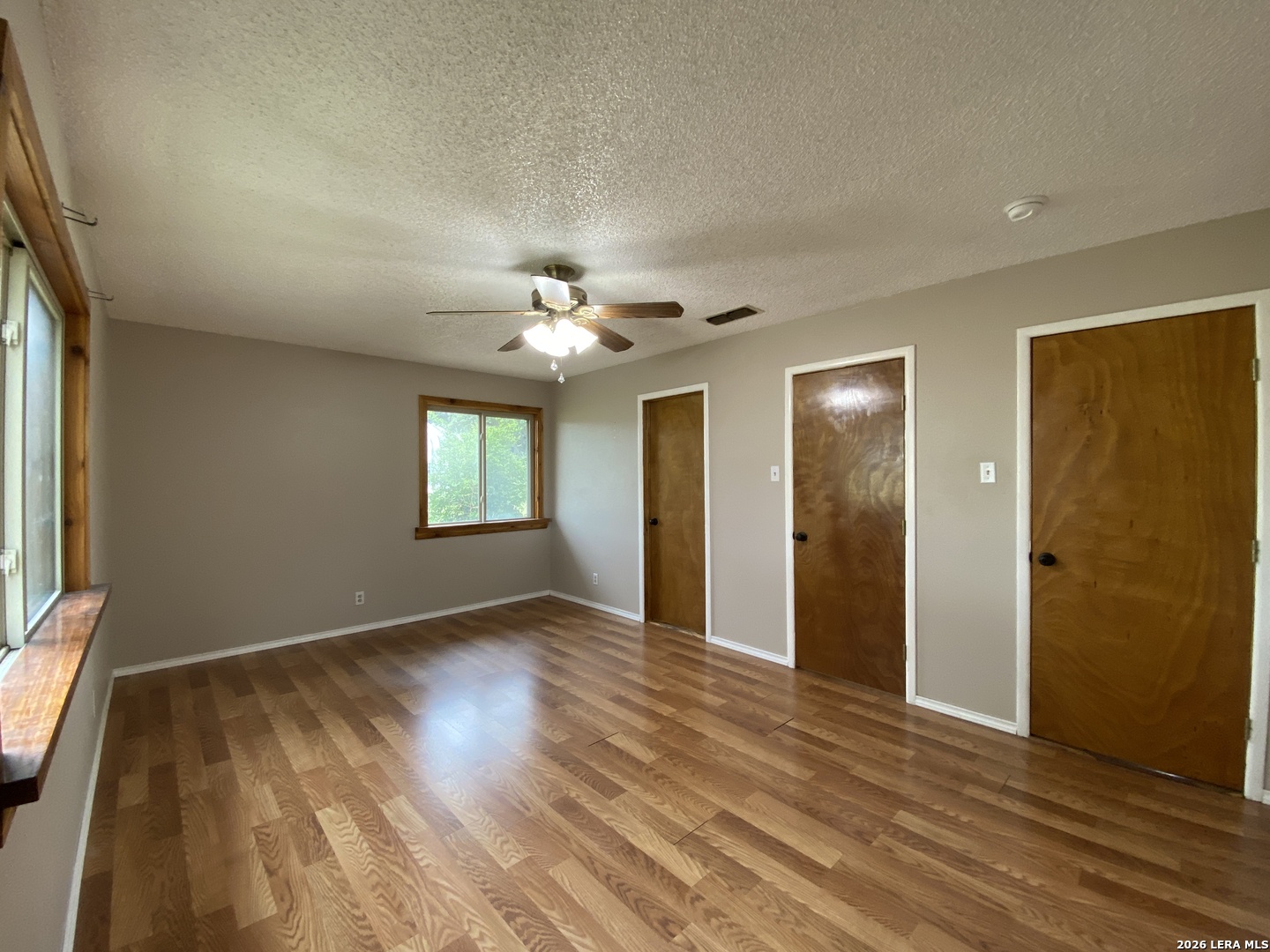 60 Wisdom Road Pleasanton, TX 78064 - Photo 26 of 29 wooden floor in an empty room with a window