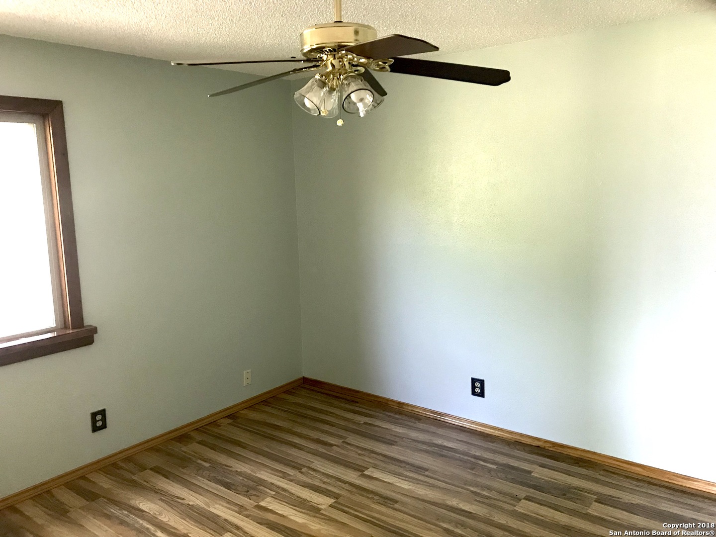 60 Wisdom Road Pleasanton, TX 78064 - Photo 5 of 29 a view of a room with wooden floor and fan