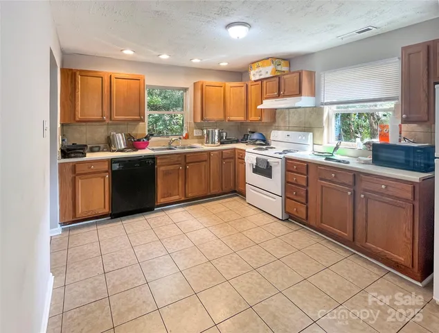 a kitchen with a sink window and cabinets