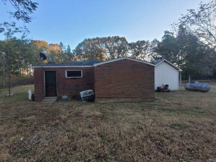 12586 Macon Road Collierville, TN 38017 - Photo 4 of 7 a view of a house with a yard and a large tree