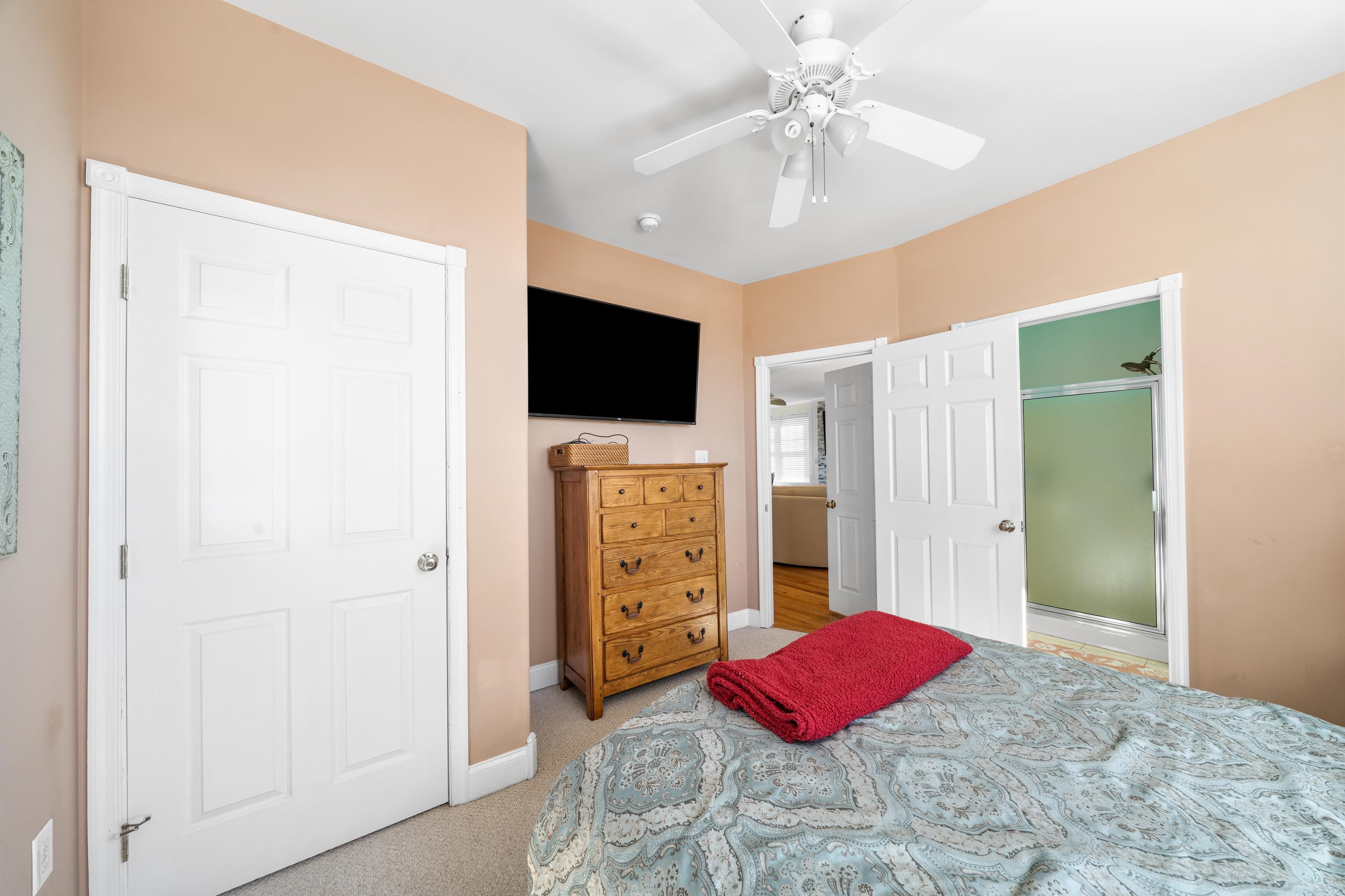 448 Avalon Avalon, NJ 08202 - Photo 23 of 32 a bedroom with a bed and a flat screen tv