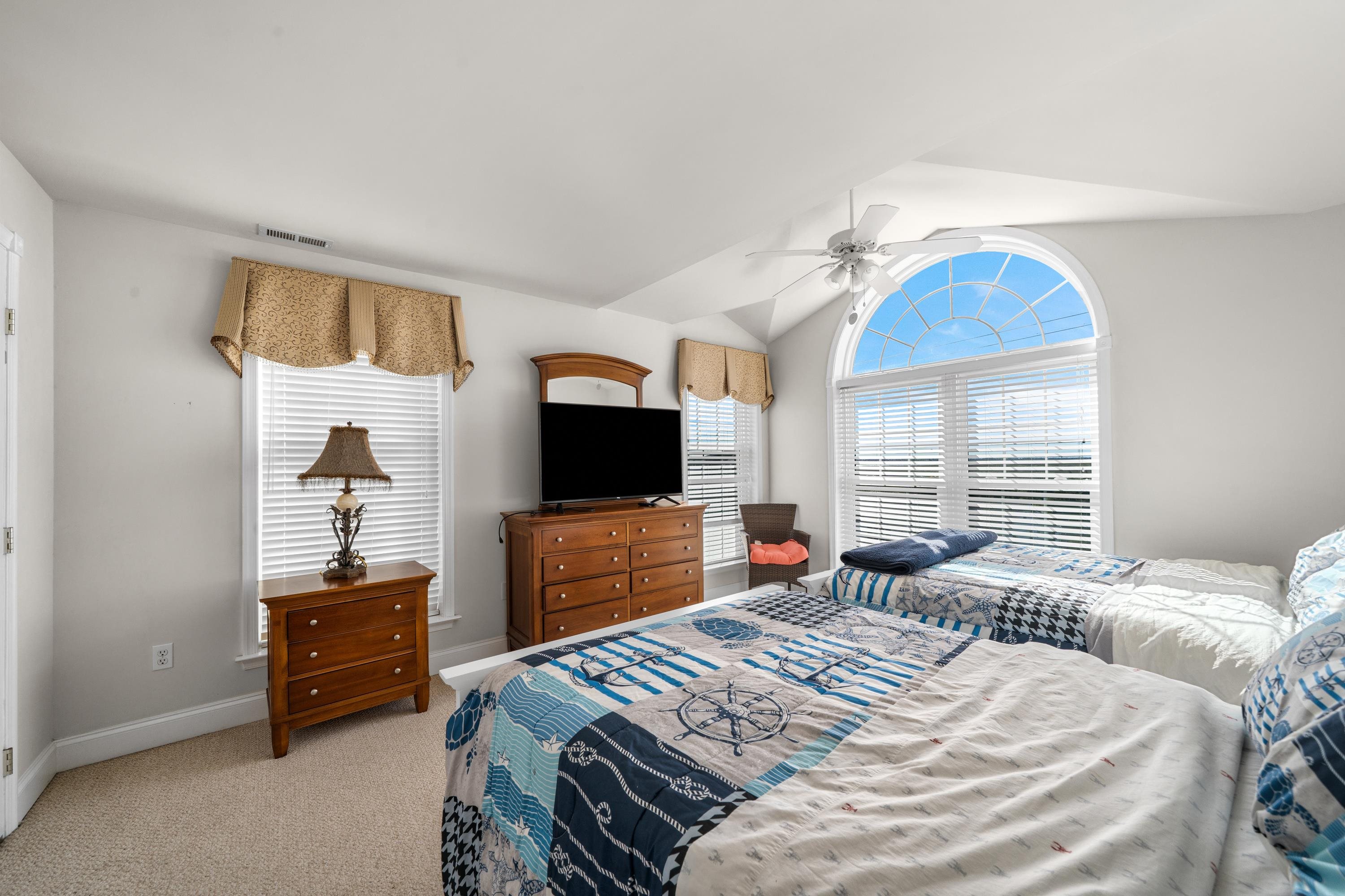448 Avalon Avalon, NJ 08202 - Photo 24 of 32 a bedroom with a bed and a flat screen tv