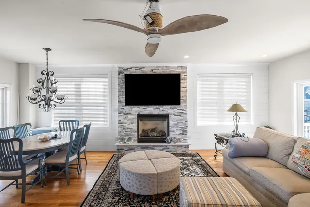 a living room with furniture a fireplace and a chandelier