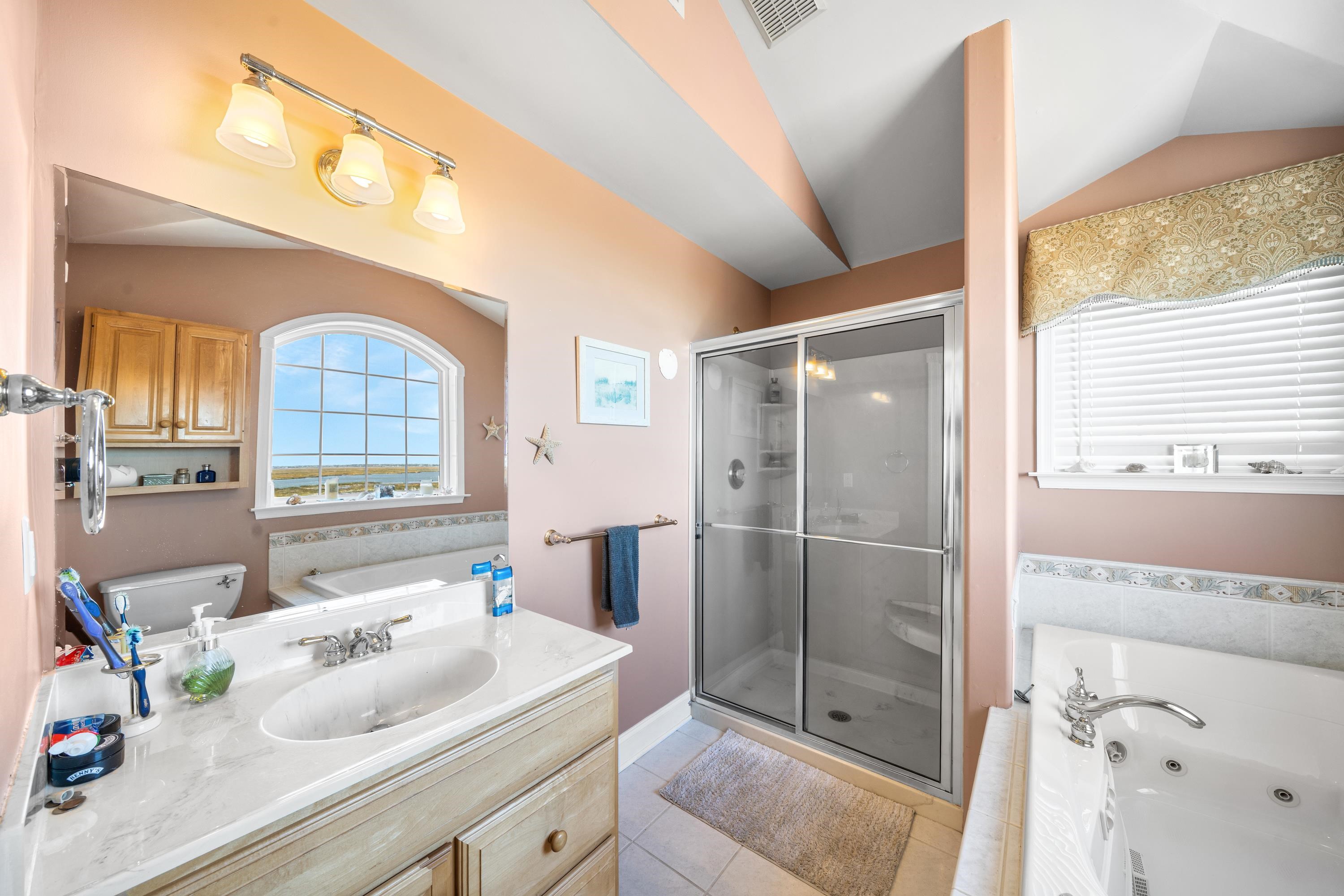 448 Avalon Avalon, NJ 08202 - Photo 8 of 32 a bathroom with a sink a vanity and a mirror