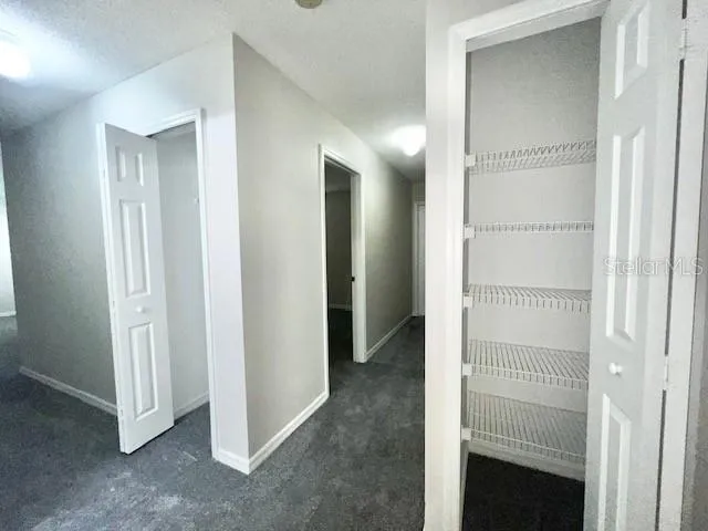 a bathroom with a granite countertop toilet and a sink