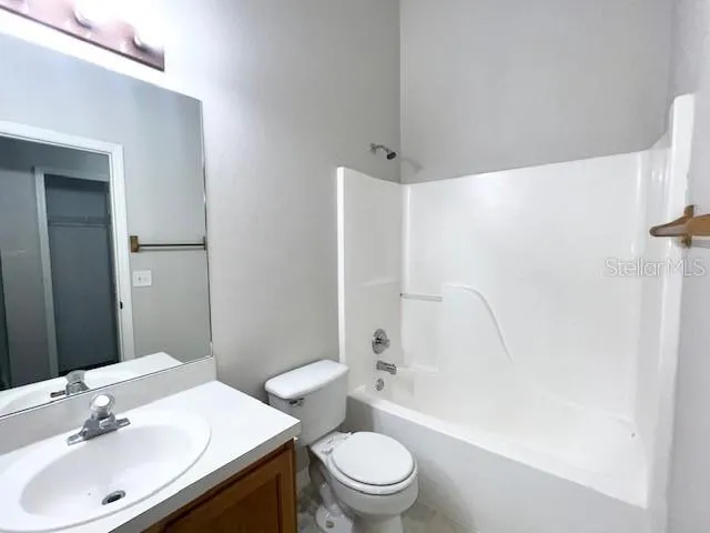 a view of a kitchen with a sink microwave and cabinets