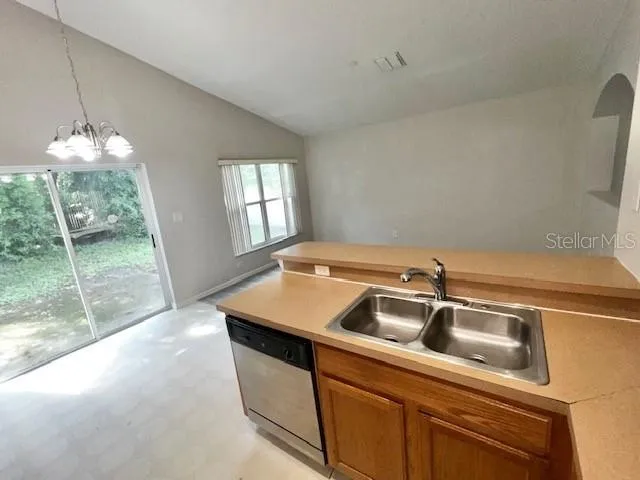 a kitchen with cabinets and stainless steel appliances