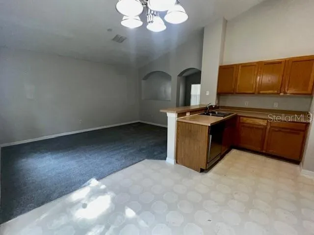 a kitchen with stainless steel appliances a refrigerator and a stove top oven